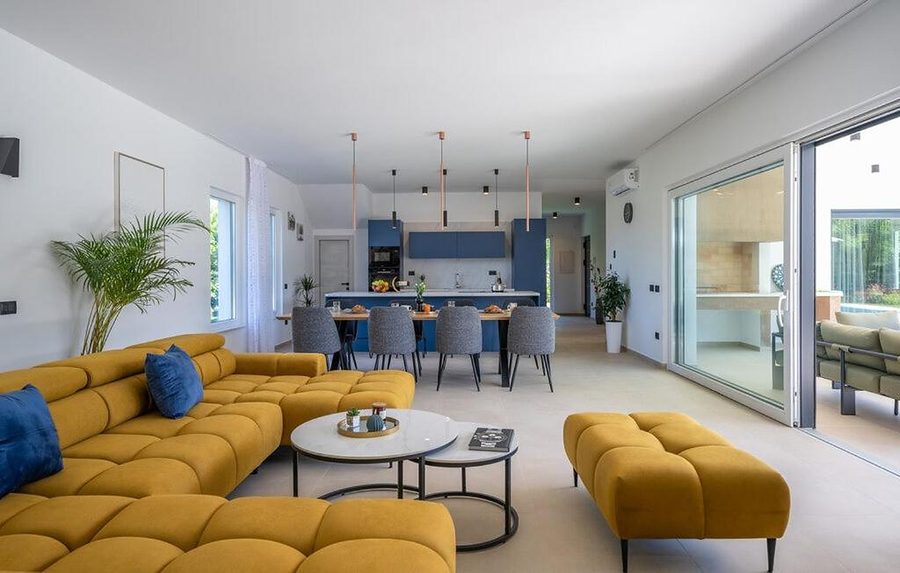 The living room of Villa Jasmina, with the dining area and kitchen behind